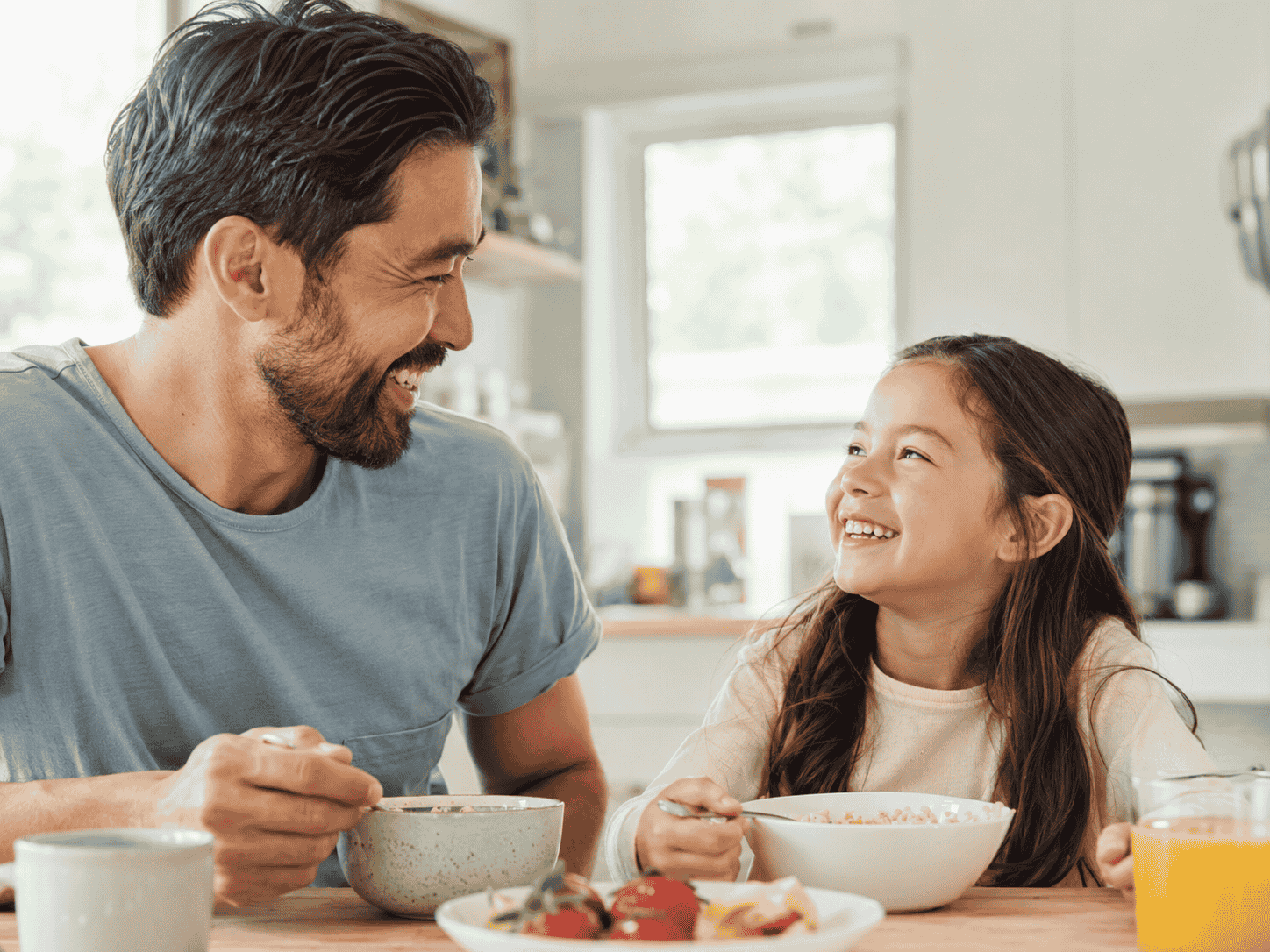 Find Fast Relief from Painful Canker Sores with Laser Treatment 6 father and daughter smiling at breakfast