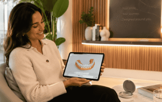 woman holding tablet showing dentures