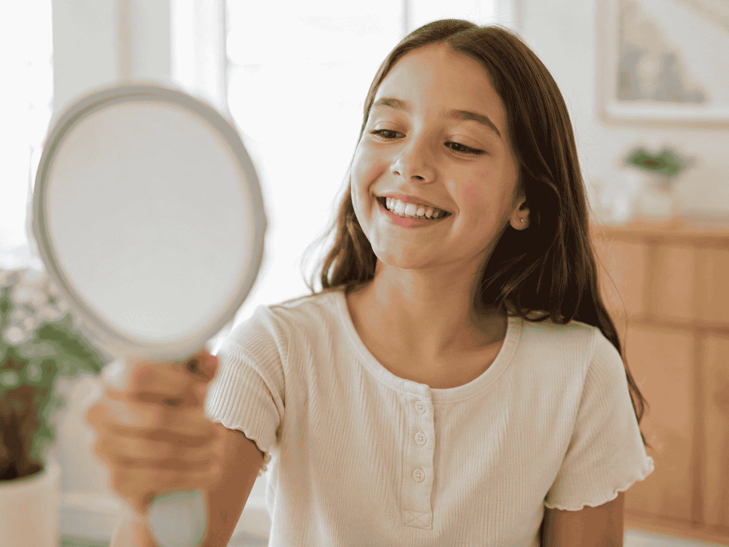 iTero Scanners and Sedation: Comfort-First Dentistry in Inglewood 6 girl looking in mirror at smile
